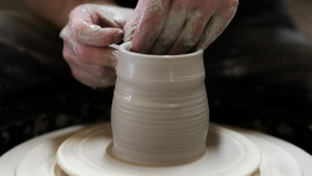 person holding round white ceramic bowl